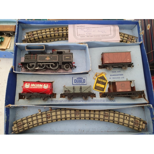 749 - Four Hornby Dublo 3-rail Goods Sets, boxes damaged and contents incomplete