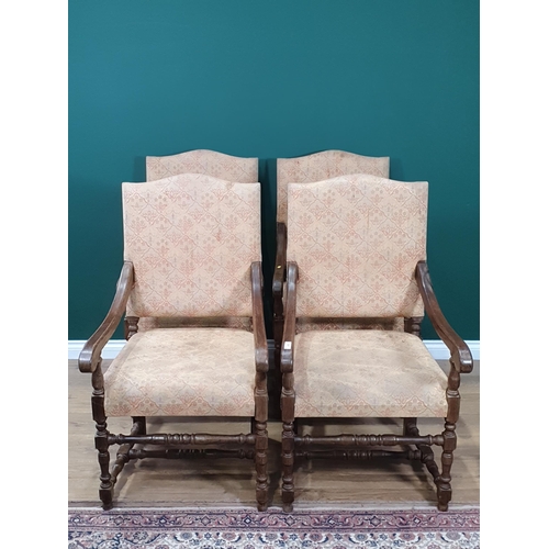 78 - A set of four beige floral upholstered oak Elbow Chairs on turned supports and stretchers.