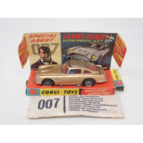 296 - Corgi Toys 261 James Bond 007 Aston Martin DB5 with figures and instructions, boxed with display