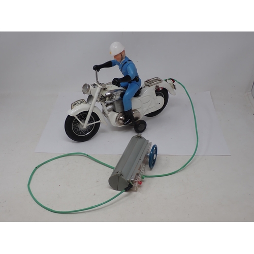 433 - A boxed Japanese Bandai battery operated remote control Police Auto Cycle