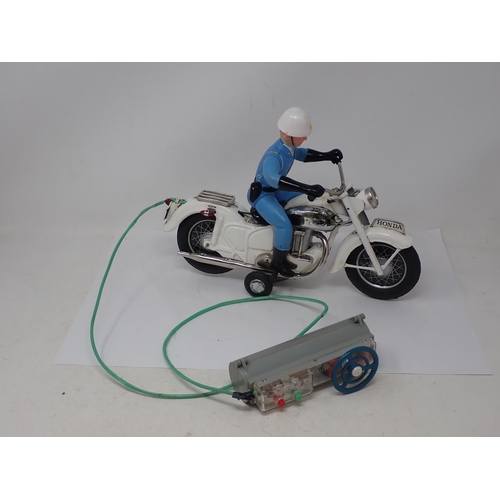 433 - A boxed Japanese Bandai battery operated remote control Police Auto Cycle