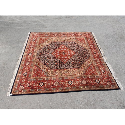 621 - A Persian style Carpet of multi-bordered design with central diamond on a red and blue ground, 9ft 9... 