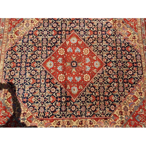 621 - A Persian style Carpet of multi-bordered design with central diamond on a red and blue ground, 9ft 9... 