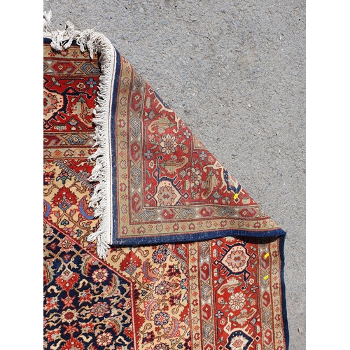 621 - A Persian style Carpet of multi-bordered design with central diamond on a red and blue ground, 9ft 9... 