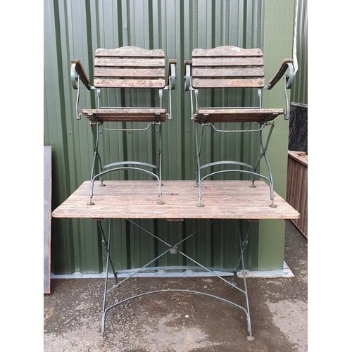 626 - A wooden and green painted Garden Table and two matching Armchairs