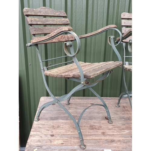 626 - A wooden and green painted Garden Table and two matching Armchairs