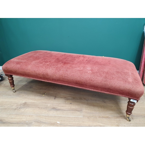 645 - A large modern re upholstered Footstool on turned supports and castors, 4ft 10