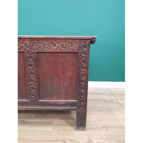 66 - A large antique oak panelled Coffer with carved scrolled decoration, 2ft 7