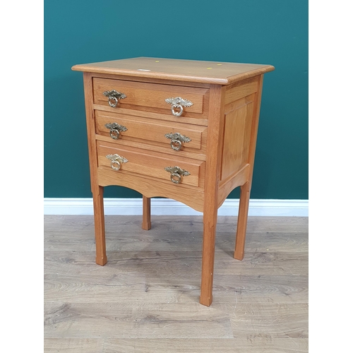 67 - A light oak Chest of three long Drawers with panelled sides on chamfered square supports, 2ft 11