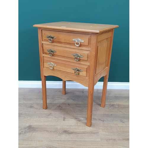 67 - A light oak Chest of three long Drawers with panelled sides on chamfered square supports, 2ft 11