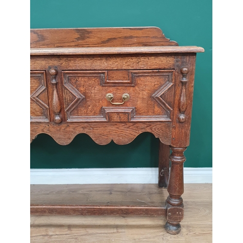 84 - An oak Sideboard with raised and shaped back, fitted three drawers with moulded decoration above sha... 