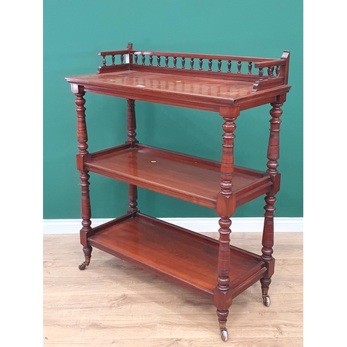 87 - A 19th Century mahogany three tier Buffet, with raised gallery back on turned supports and castors, ... 