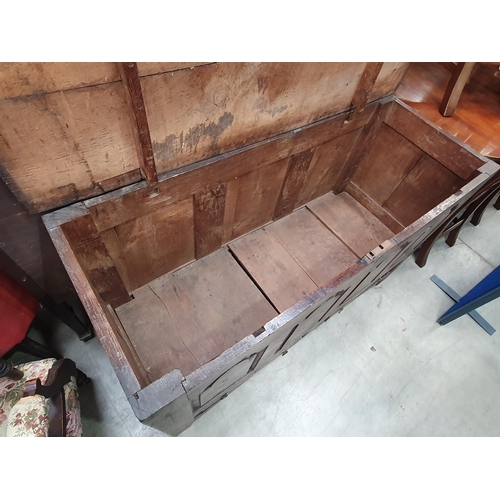 36 - An antique oak Mule Chest, the two plank lid above arched panel front, above pair of fitted drawers,... 