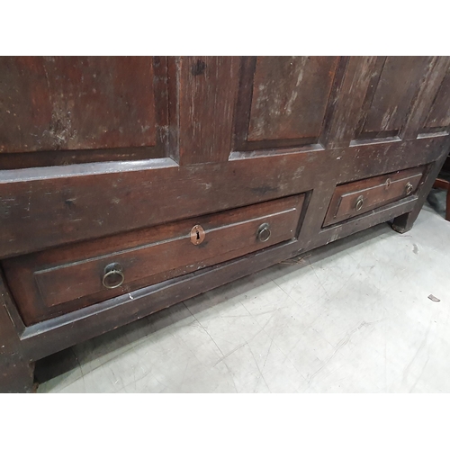 36 - An antique oak Mule Chest, the two plank lid above arched panel front, above pair of fitted drawers,... 