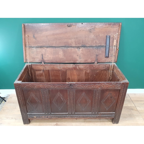 100 - A 17th Century oak Coffer with two plank lid above lozenge carved four panel front on stile supports... 