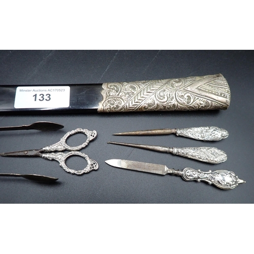 133 - A silver-handled ebonised Page Turner, a pair of George III silver Sugar Tongs, London 1811, silver-... 