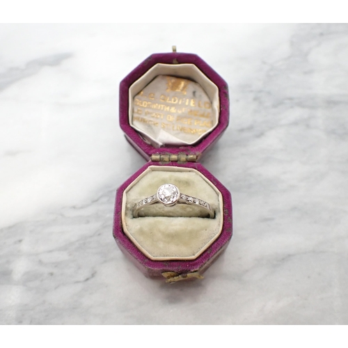 155 - An early 20th Century Diamond Ring rubover-set old-cut stone between smaller stones pavé-set to shou... 