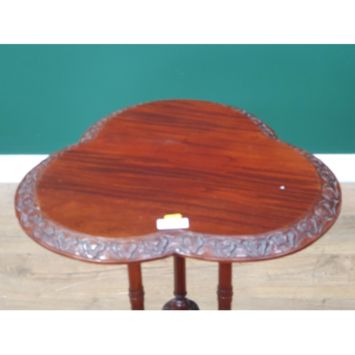 16 - A reproduction mahogany Occasional Table with clover shaped top, above shaped supports on tripod bas... 