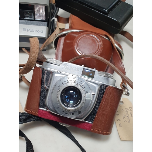 217 - A Beirette Junior II Camera in case, a Polaroid Image System, an Agfa Karat Camera in case, a Voigtl... 