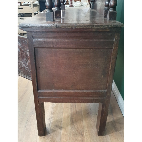 24 - A carved oak Coffer converted into Cupboard, the top section with fall front above pair of fitted dr... 