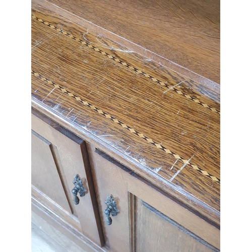 26 - An oak Bookcase with pair of leaded glass doors above open shelf, the bottom section fitted pair of ... 