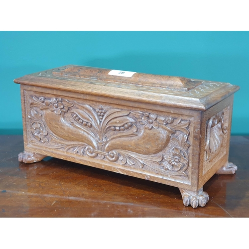 29 - A carved oak Casket with hinged lid enclosing two division lift out tray, with floral and leafage de... 