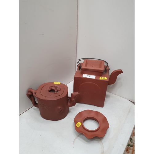 342 - Two Chinese terracotta Teapots and Covers and a terracotta Stand