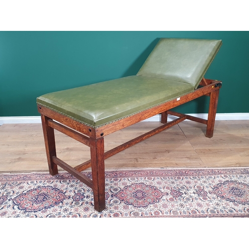 4 - An oak framed Vintage Doctors/Examination Table with adjustable Headrest and green rexine upholstery... 