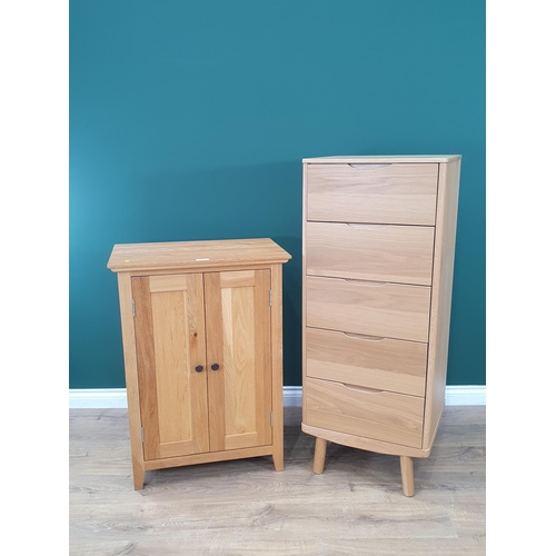 495 - A modern light oak Cupboard the panelled doors enclosing shelved interior 3ft High x 2ft 2