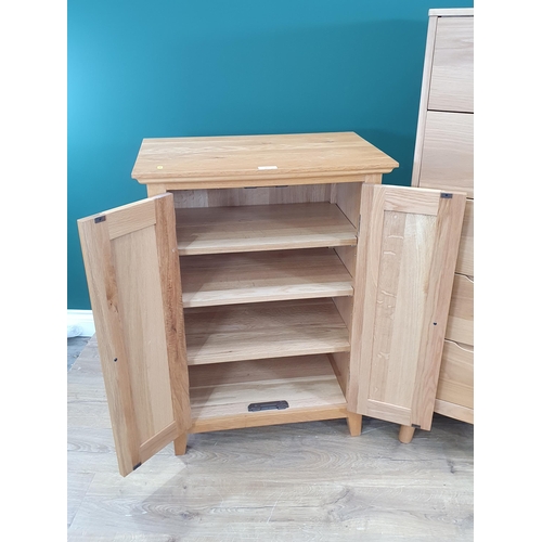 495 - A modern light oak Cupboard the panelled doors enclosing shelved interior 3ft High x 2ft 2