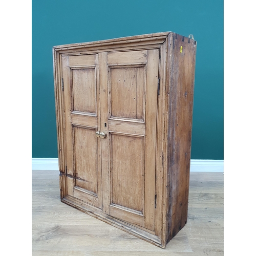 52 - A rustic pine Wall Cupboard with pair of panelled doors enclosing shelved interior, 3ft High x 28