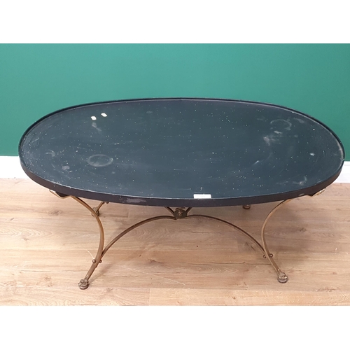 589 - An oval ebonised Occasional Table, on shaped brass support and dolphin head terminals, 3ft 4