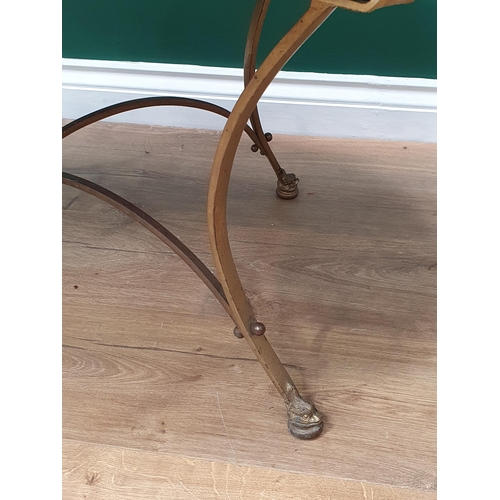 589 - An oval ebonised Occasional Table, on shaped brass support and dolphin head terminals, 3ft 4