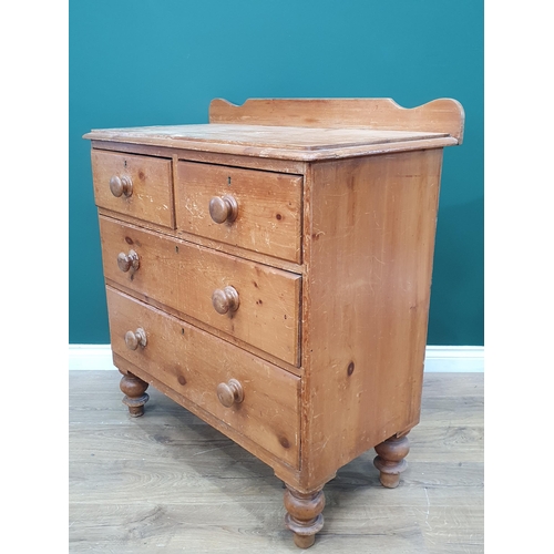 608 - A pine Chest of two short, two long Drawers with shaped gallery back on turned supports, 3ft 3