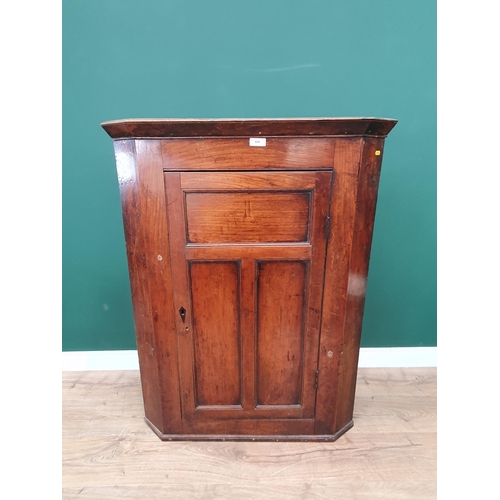 610 - An antique Elm Hanging Corner Cupboard the panelled door enclosing shaped shelved interior, 3ft 9