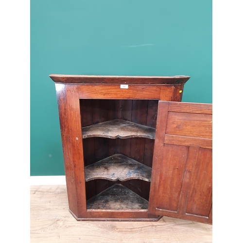 610 - An antique Elm Hanging Corner Cupboard the panelled door enclosing shaped shelved interior, 3ft 9