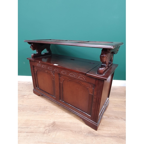 611 - A reproduction oak Monks Bench with lion supports and box seat, 2ft 5