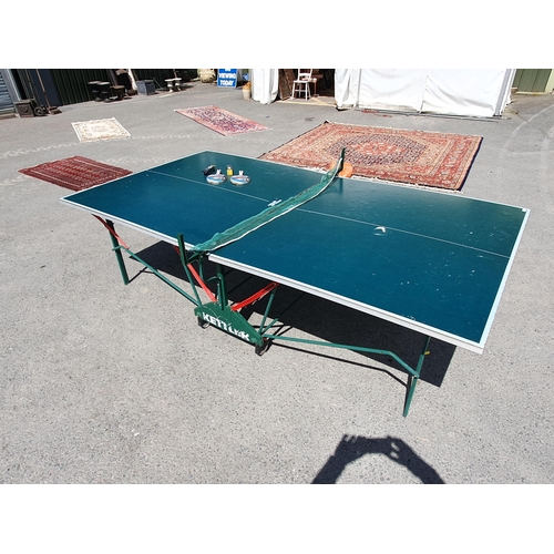 614 - A Kettler folding Table Tennis Table including bats balls and net, A/F and missing one net support