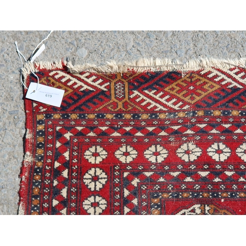 619 - A small Persian Rug, the centre with rose of medallions on a red ground, worn, 5ft 4in x 3ft 1in