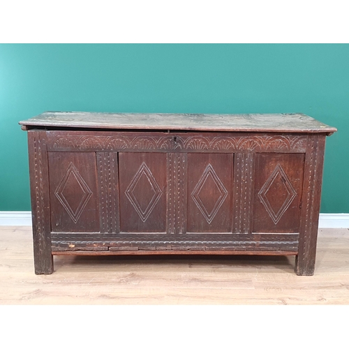 503 - A 17th Century oak Coffer with two plank lid above lozenge carved four panel front on stile supports... 