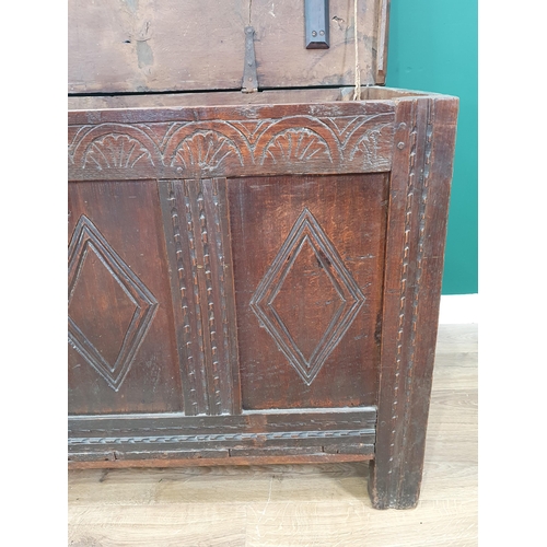 503 - A 17th Century oak Coffer with two plank lid above lozenge carved four panel front on stile supports... 