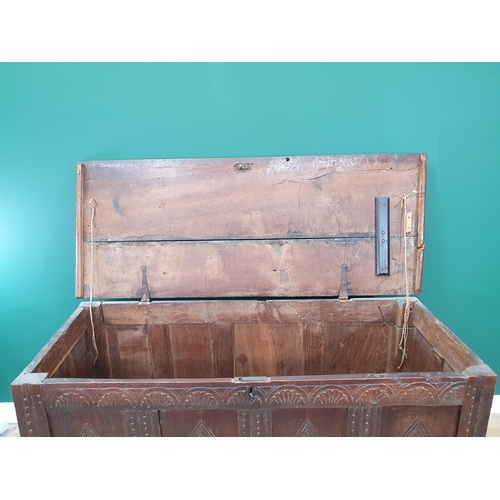 503 - A 17th Century oak Coffer with two plank lid above lozenge carved four panel front on stile supports... 