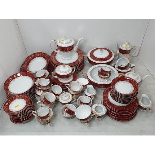 319 - A large quantity of 'Sunny' china dinnerware, decorated gilding and red borders, some chipped