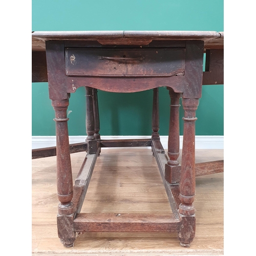 11 - An antique oak Gateleg Table with single fitted drawer on turned and tapered supports, A/F, 4ft 4