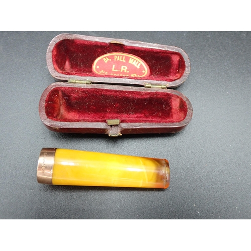 110 - An Edward VII 15ct gold mounted Cigarette Holder, Birmingham 1905, in case, and two old Pipes