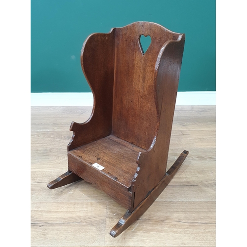 15 - An antique oak Childs Rocking Chair with pierced heart decoration.