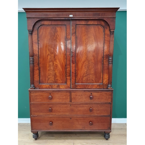 20 - A 19th Century flamed mahogany Linen Press, the top section with pair of panelled doors flanked by t... 