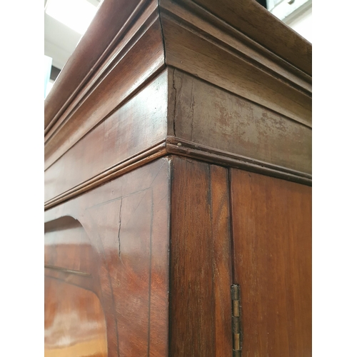 20 - A 19th Century flamed mahogany Linen Press, the top section with pair of panelled doors flanked by t... 