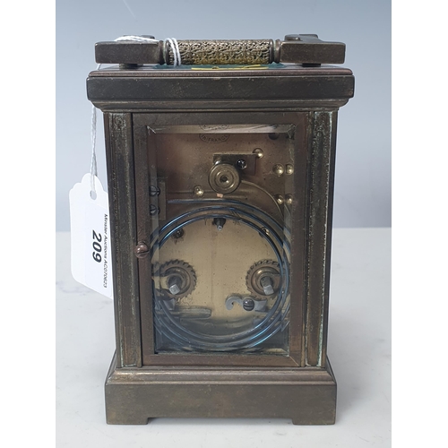 209 - A brass cased repeater Carriage Clock with white enamel dial and corner foliate decoration, 5in H