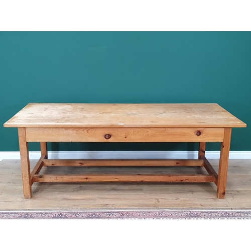 21 - A large Pine Kitchen Table on square supports and twin stretchers, 7ft Long x 3ft Wide x 2ft 6